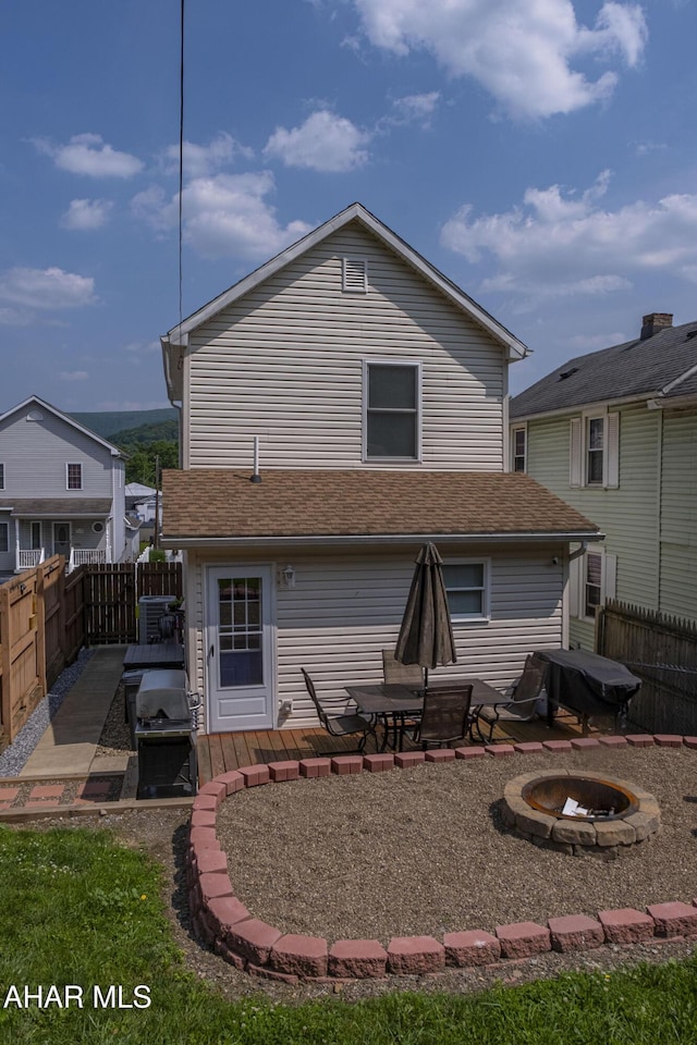 1407 N 5th Ave, Altoona, PA 16601 - back of property with an outdoor fire pit and a fenced backyard