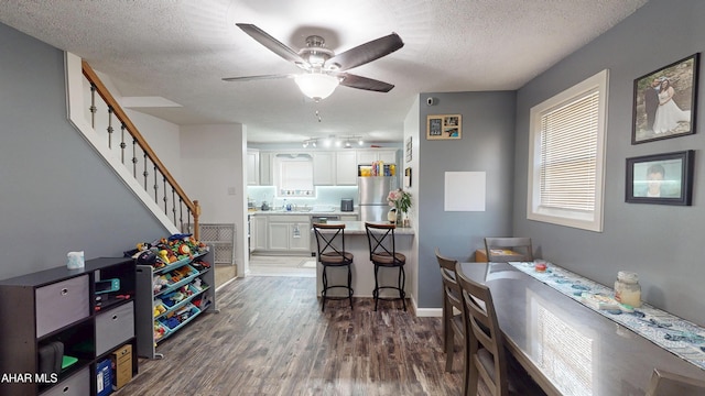 1407 N 5th Ave, Altoona, PA 16601 - dining area with ceiling fan, dark wood-style floors, a textured ceiling, and stairs