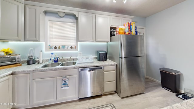 1407 N 5th Ave, Altoona, PA 16601 - kitchen featuring stainless steel appliances, white cabinets, light wood finished floors, and light countertops