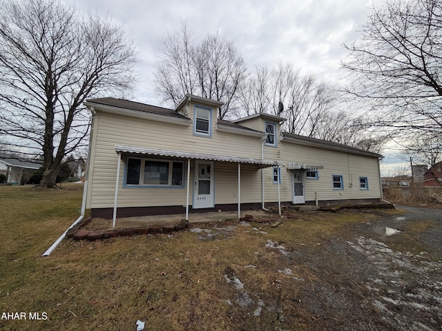 view of front of house with entry steps, a patio, and a front yard