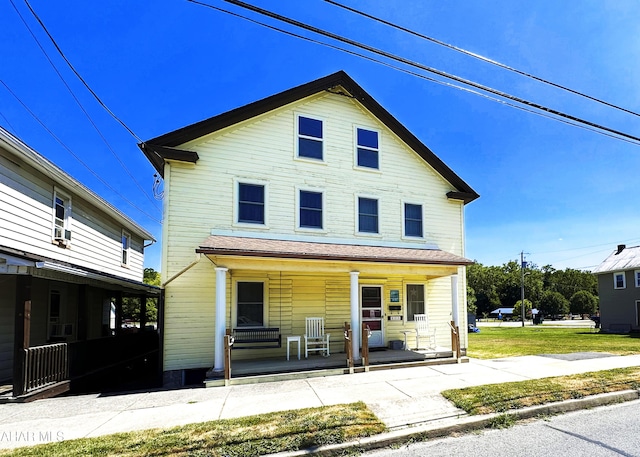 view of front property with covered porch and a front lawn