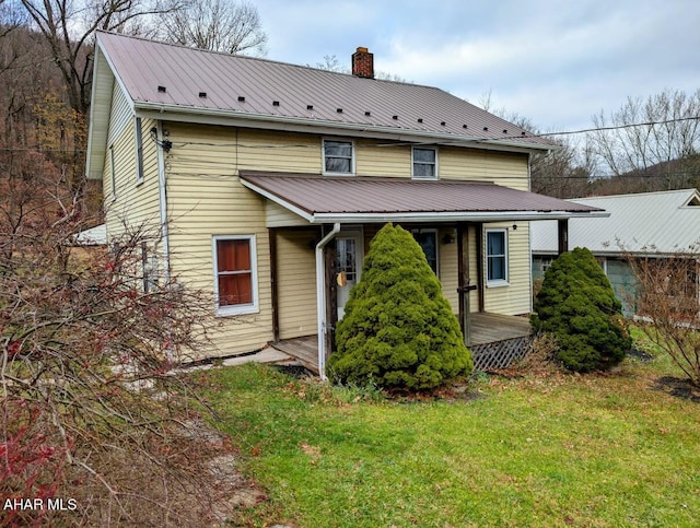 rear view of property featuring a yard