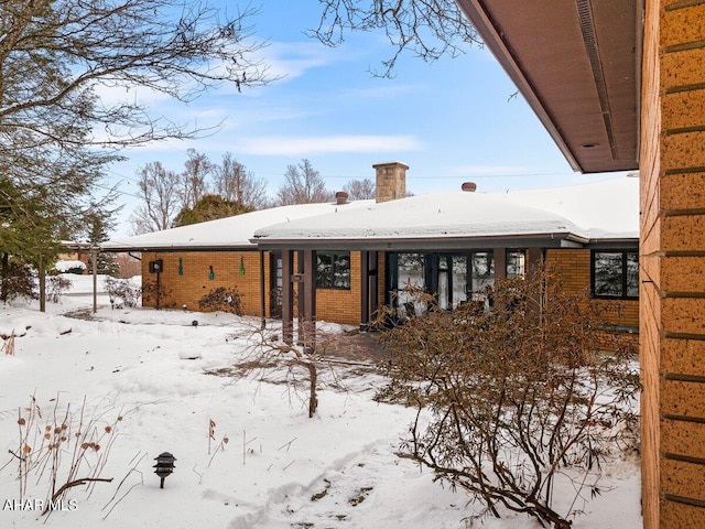 view of snow covered rear of property