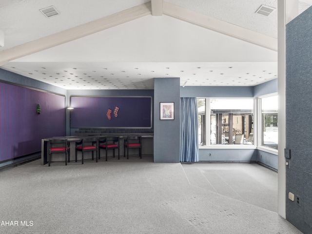 interior space with vaulted ceiling with beams