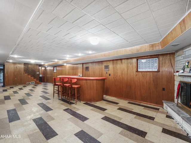 bar with a stone fireplace and wooden walls