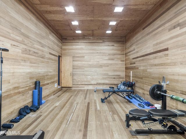 workout room with wooden walls, wood ceiling, and hardwood / wood-style floors