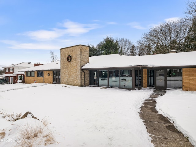 view of snow covered back of property