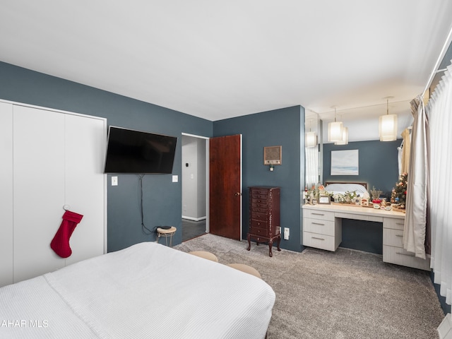 carpeted bedroom featuring built in desk