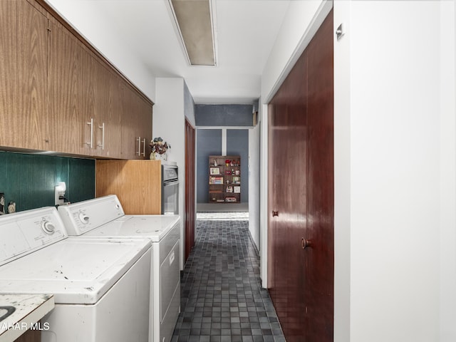 washroom featuring separate washer and dryer and cabinets