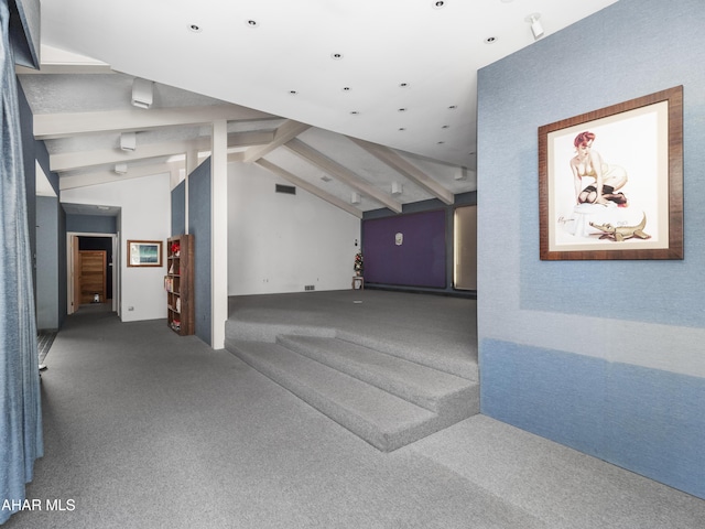 interior space featuring carpet flooring and vaulted ceiling with beams