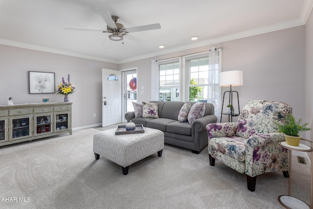 carpeted living room with crown molding and ceiling fan