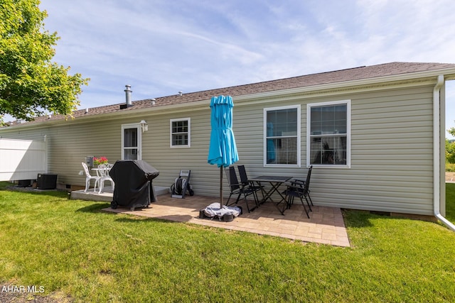 back of house with a lawn, a patio, and central AC