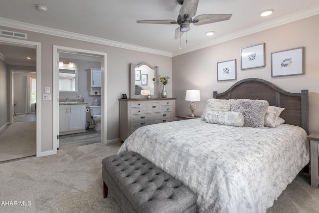 bedroom featuring light carpet, ornamental molding, ceiling fan, sink, and connected bathroom