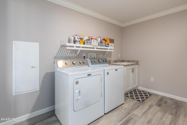 washroom featuring sink, light hardwood / wood-style flooring, crown molding, and washing machine and clothes dryer