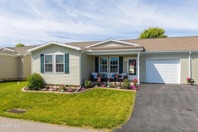 single story home featuring covered porch, a garage, and a front yard