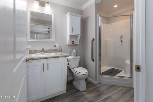 bathroom with wood-type flooring, vanity, an enclosed shower, and ornamental molding