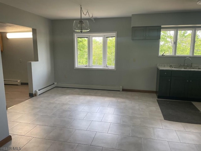 unfurnished dining area with sink, light tile patterned floors, and a baseboard radiator