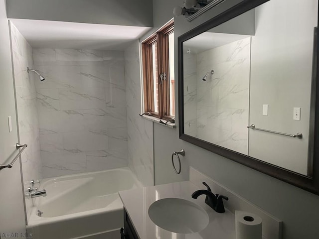 bathroom featuring vanity and tiled shower / bath