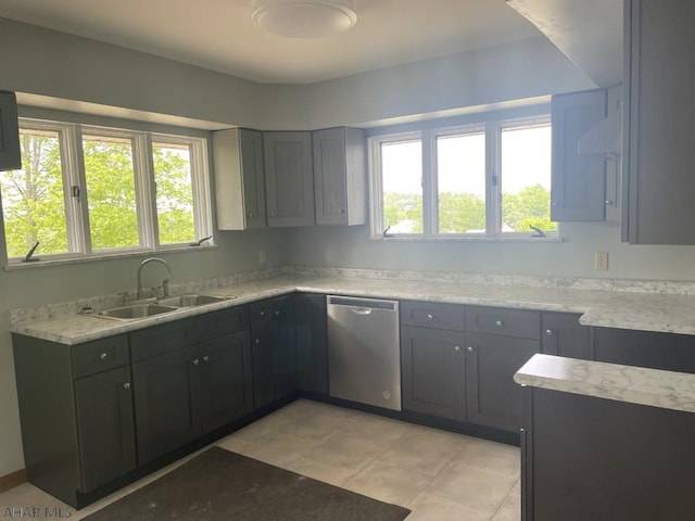 kitchen featuring dishwasher, gray cabinets, light tile patterned floors, and sink