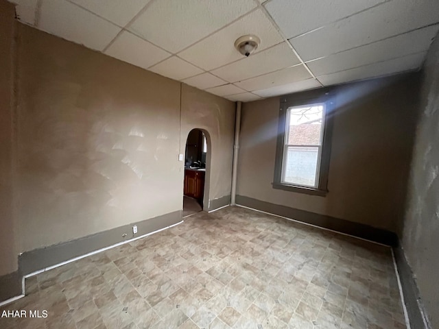 unfurnished room with a paneled ceiling