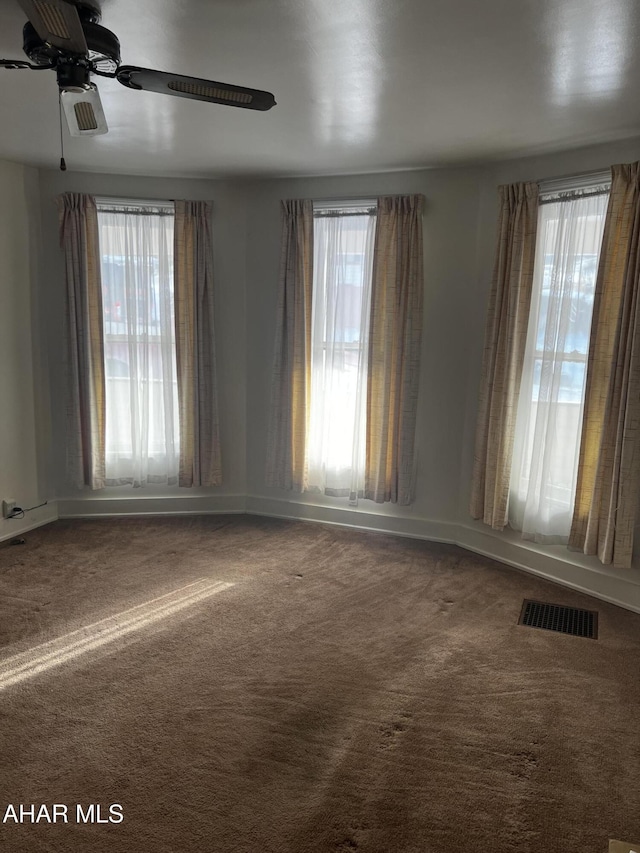 carpeted empty room featuring ceiling fan