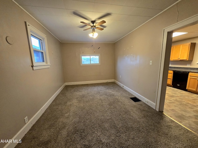 carpeted spare room featuring ceiling fan and crown molding