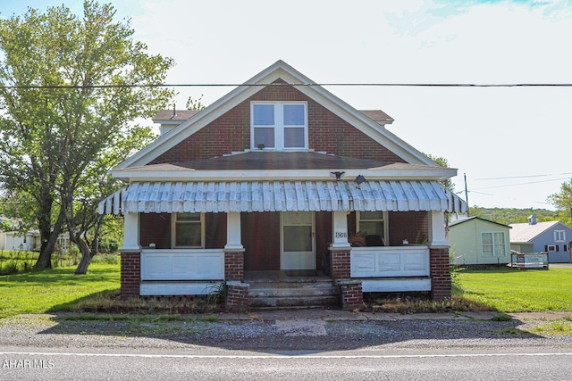 view of front of home featuring a porch and a front yard