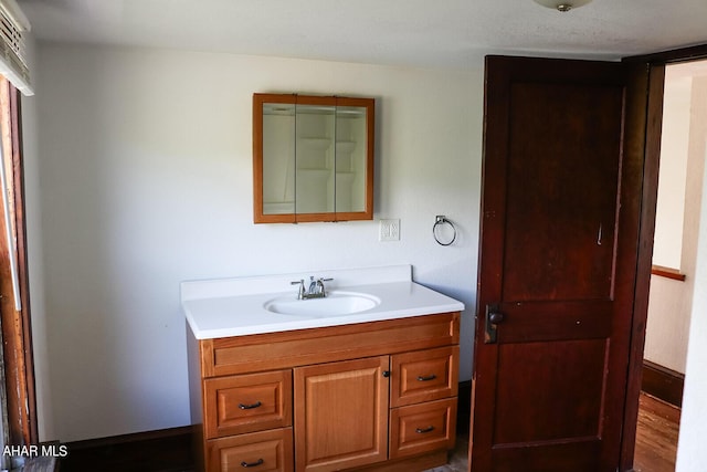 bathroom featuring wood-type flooring and vanity