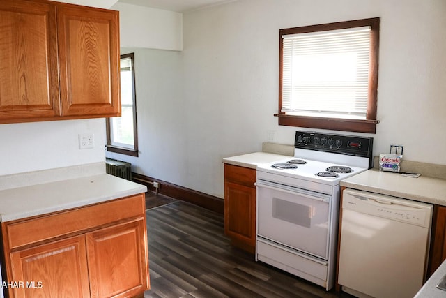 kitchen with white appliances, radiator, and dark wood-type flooring