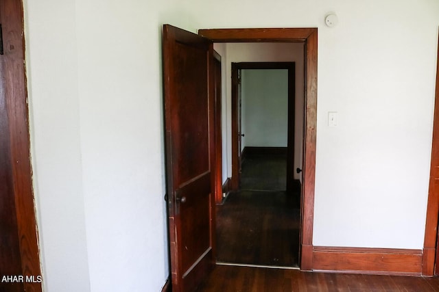 hallway with dark wood-type flooring