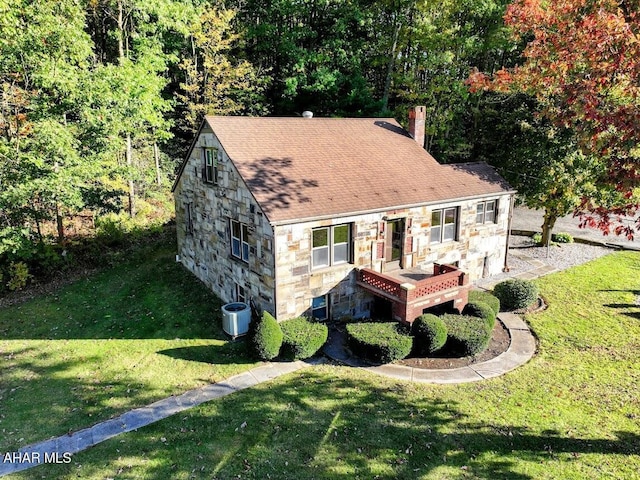 view of front of house featuring a front yard and cooling unit