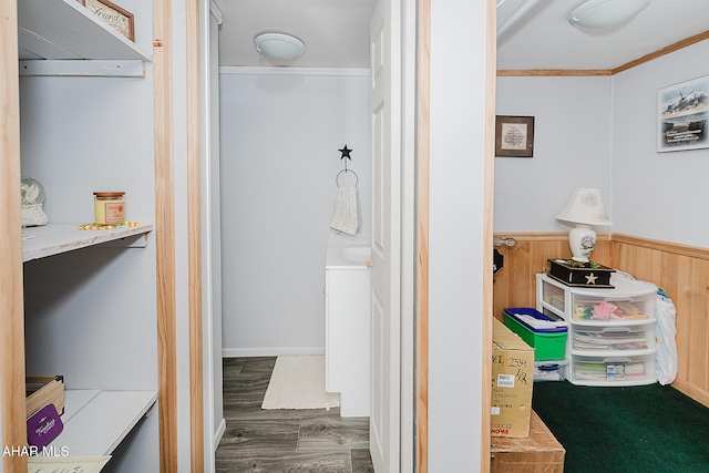 bathroom with hardwood / wood-style flooring, ornamental molding, and wooden walls