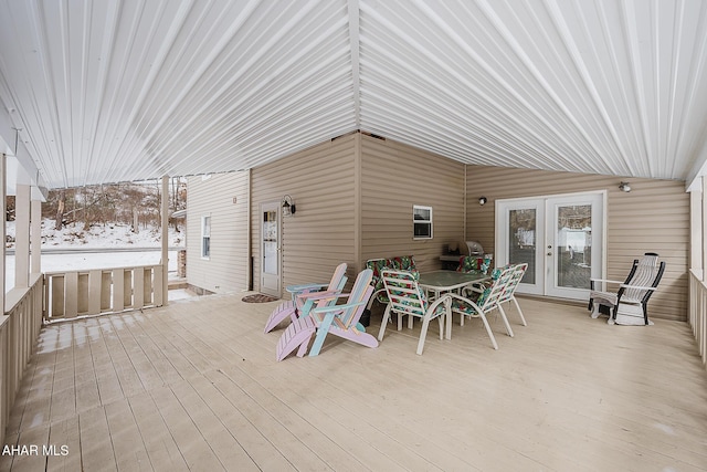 snow covered deck featuring french doors