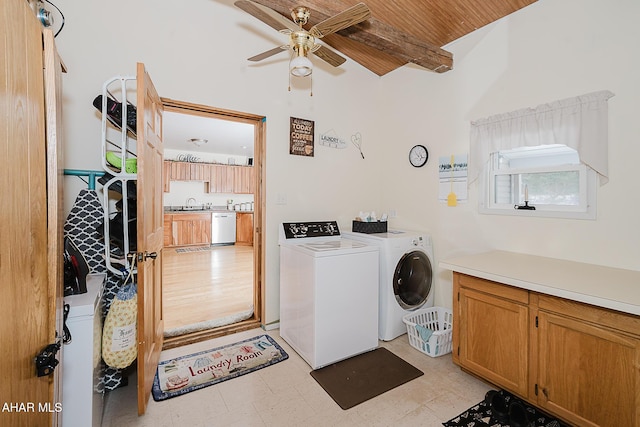 clothes washing area with ceiling fan, sink, wood ceiling, separate washer and dryer, and cabinets