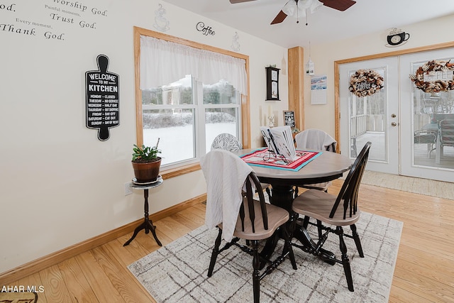 dining space featuring ceiling fan, wood-type flooring, and french doors