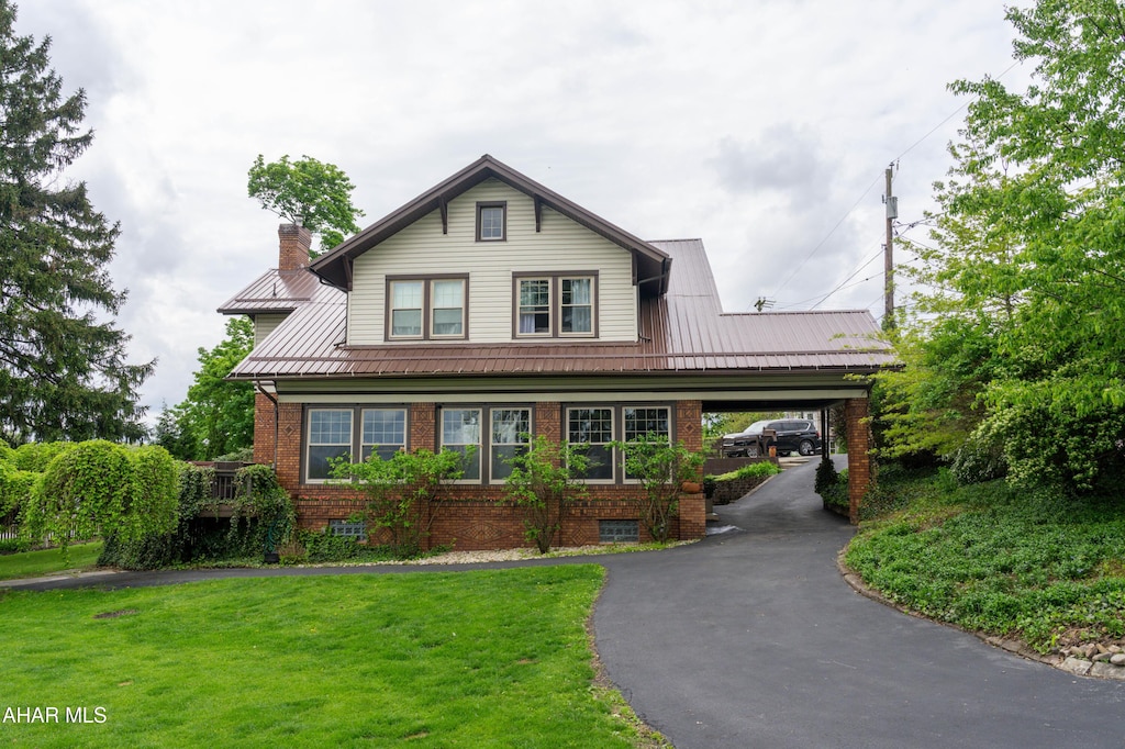 3216 Beale Ave, Altoona, PA 16601 - view of front of property with brick siding, a front lawn, metal roof, and driveway