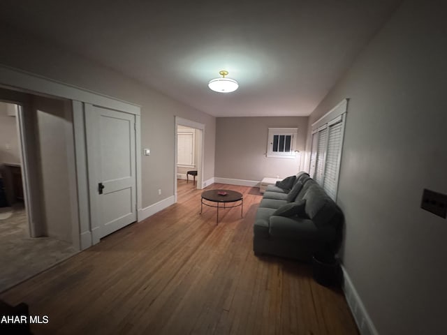 living room featuring baseboards and wood finished floors