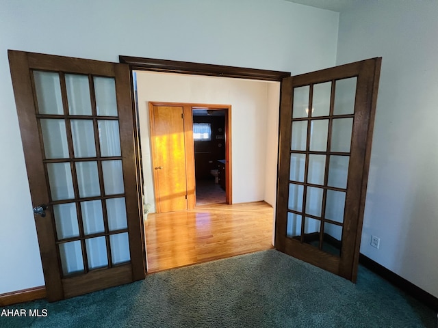 spare room with french doors and hardwood / wood-style floors