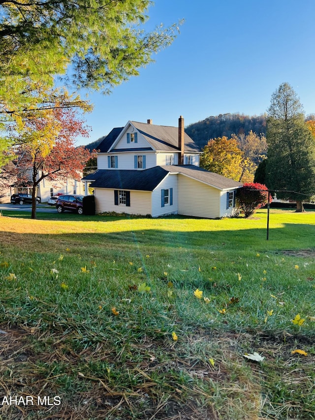 view of property exterior with a lawn