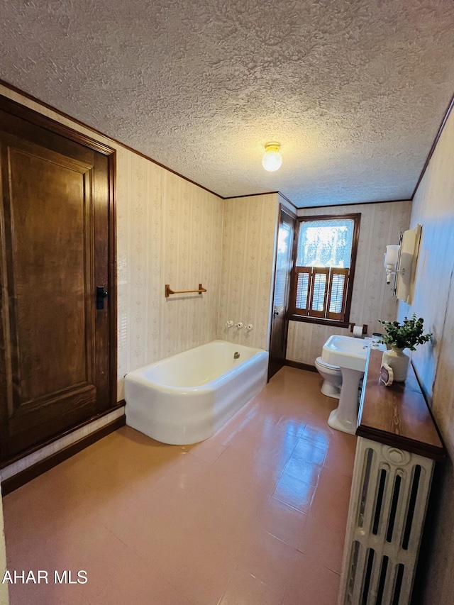 bathroom featuring a textured ceiling and a bathing tub