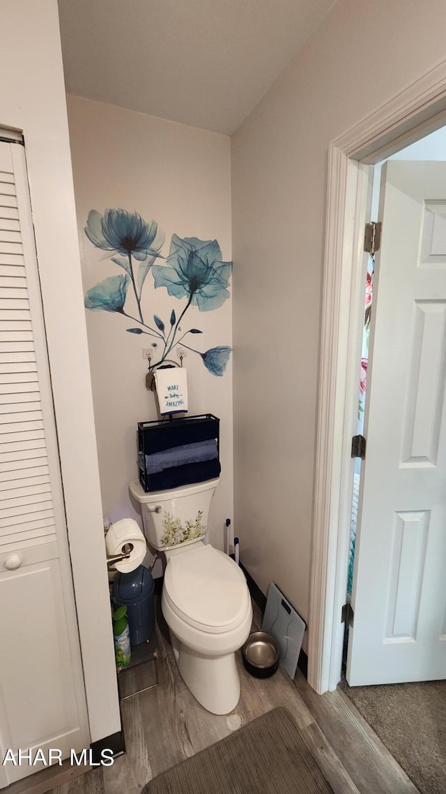 bathroom with hardwood / wood-style floors and toilet