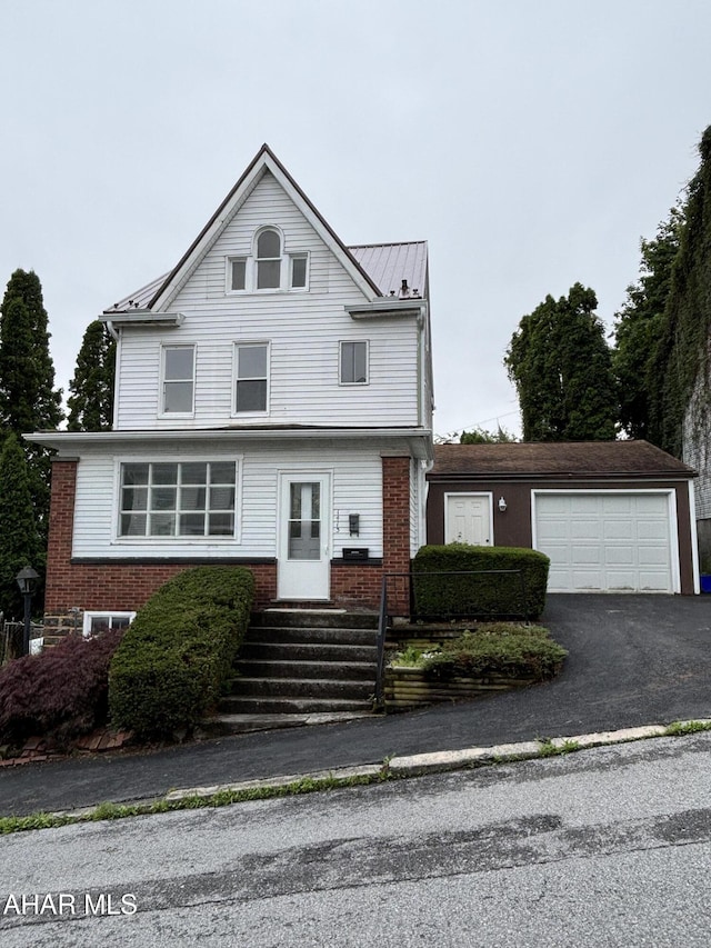 1413 17th Ave, Altoona, PA 16601 - view of front of house featuring entry steps, a standing seam roof, asphalt driveway, a metal roof, and brick siding
