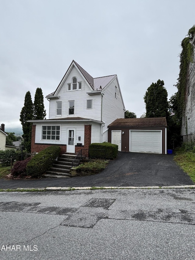 1413 17th Ave, Altoona, PA 16601 - traditional home with asphalt driveway, an attached garage, an outdoor structure, and brick siding