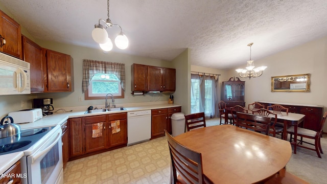 1647 Saint Francis Ln, Altoona, PA 16602 - kitchen with a chandelier, white appliances, plenty of natural light, a textured ceiling, and light countertops