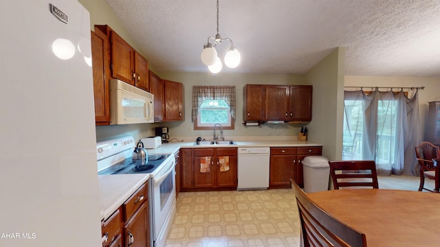 1647 Saint Francis Ln, Altoona, PA 16602 - kitchen featuring white appliances, a chandelier, light flooring, a textured ceiling, and light countertops