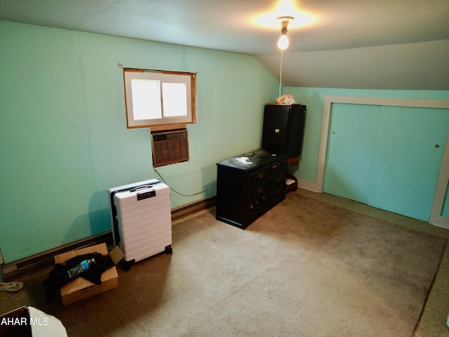 unfurnished office with light colored carpet, lofted ceiling, and a wall unit AC