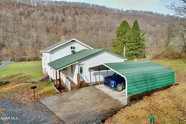 view of front of property with a front yard and a carport