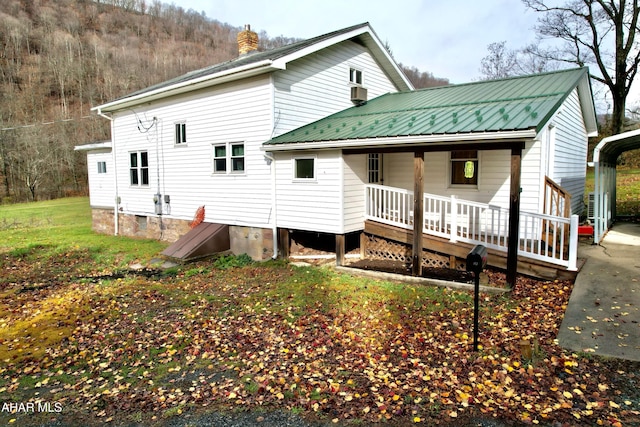 rear view of property with a porch