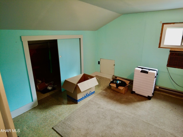 bonus room featuring carpet, vaulted ceiling, and an AC wall unit