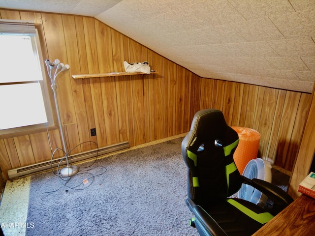 additional living space with wood walls, carpet, a baseboard radiator, and lofted ceiling